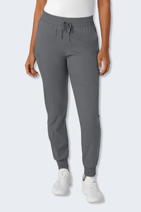 Close-up of a female healthcare professional wearing Wink Boundless 5151 scrub pants in pewter. These jogger-style scrub pants feature an elastic waistband with a drawstring for a secure fit, multiple pockets for convenience, and ribbed cuffs at the ankles for a modern, comfortable look. Ideal for those seeking both functionality and style in their medical uniforms.