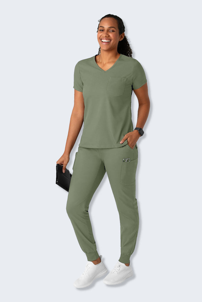 Sage Green Wink Boundless Women's Scrub Set, featuring the 6151 Women's Scrub Top with a modern V-neck design and the 5151 Women's Scrub Pants with a straight-leg fit. Both pieces are crafted from soft, breathable, and sustainable fabric, offering multiple pockets for practicality and comfort. Perfect for healthcare professionals seeking style and functionality. Supplied by Infectious Clothing Co.