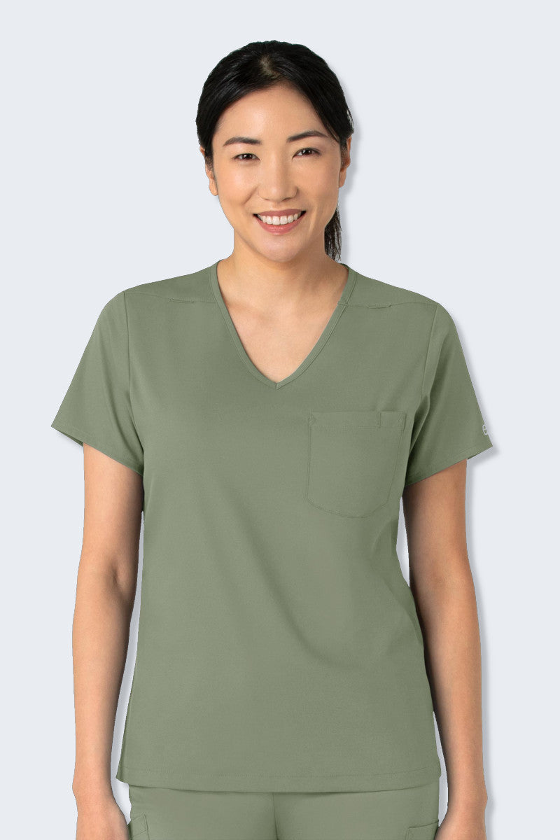 WonderWink Boundless 6151 Women's Scrub Top in Sage Green, featuring a curved V-neck, high-to-low hem, and practical pockets. Made from soft, stretchy, and sustainable fabric, perfect for healthcare professionals seeking comfort and style. Supplied by Infectious Clothing Co.