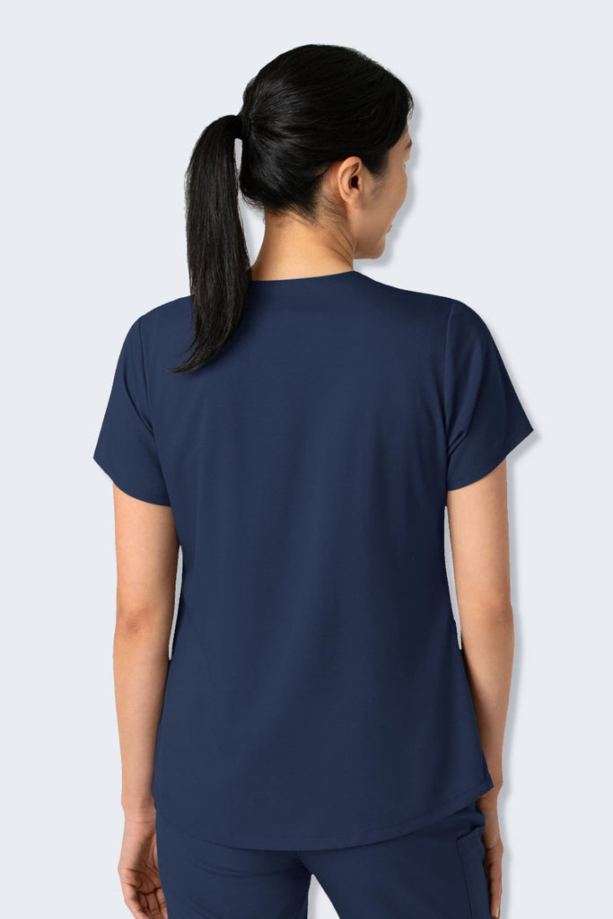 Back view of the WonderWink Boundless 6251 Women's V-neck Scrub Top in Navy, showcasing its clean, modern lines and gently curved hem for a flattering fit. Made from soft, stretchy, and sustainable fabric, designed for comfort and ease of movement during a busy workday. Supplied by Infectious Clothing Co.