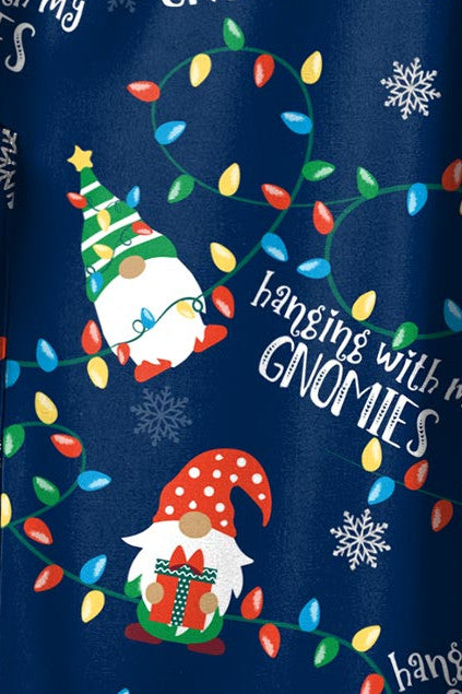 Close-up of a festive Christmas scrub print featuring cheerful gnomes with holiday lights and snowflakes, with the text 'Hanging with my Gnomies,' available at Infectious Clothing Co. in Australia.