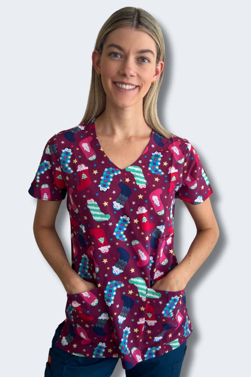 Penguin Pals Christmas Scrub Top Model Front View | Infectious Clothing Company