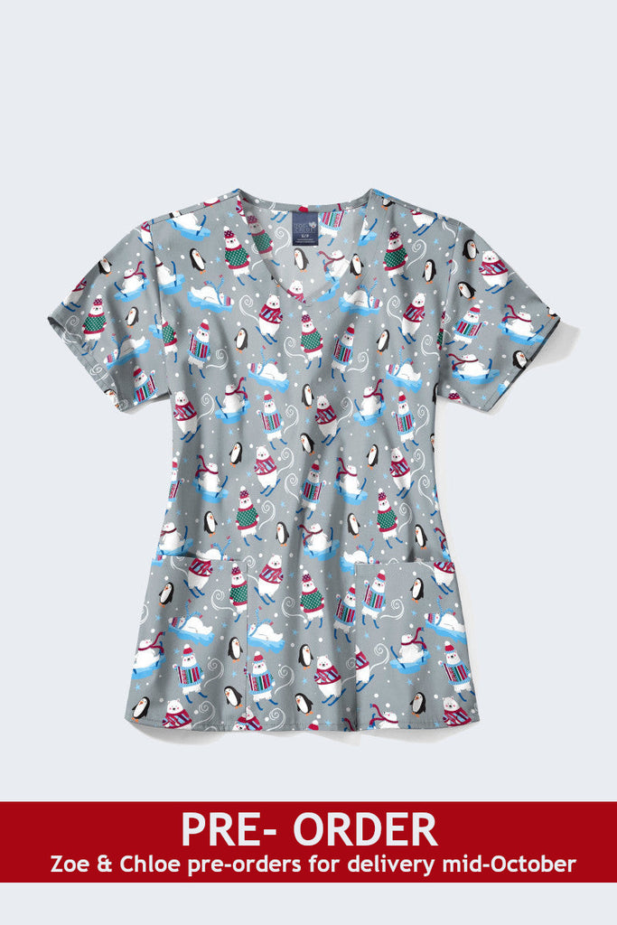 Available now Winter-themed Christmas scrub top featuring playful snowmen and penguins on sleds, set against a light grey background, perfect for adding holiday spirit to your workwear. 