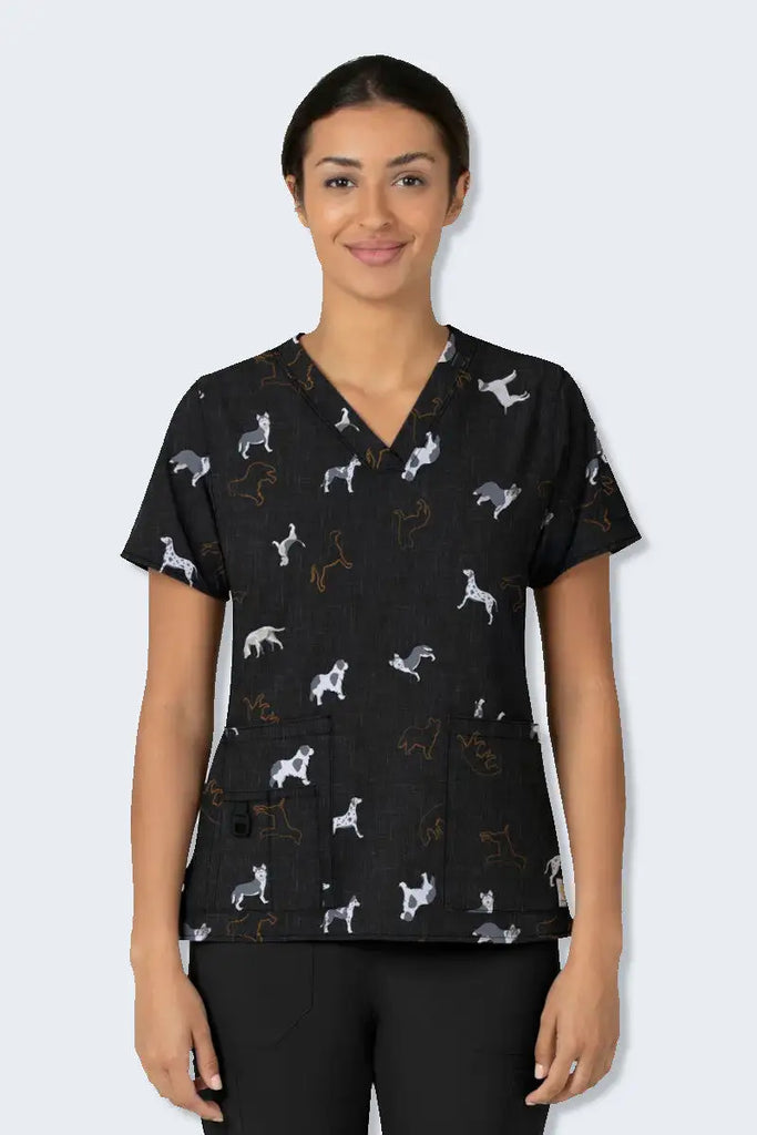 Carhartt Doggy Display animal printed scrub top for women, featuring a limited edition fashion print design. This stretchy, durable scrub top offers all-day comfort with FastDry technology, multiple pockets, and Rugged Flex stretch technology, made from 94% polyester and 6% spandex.